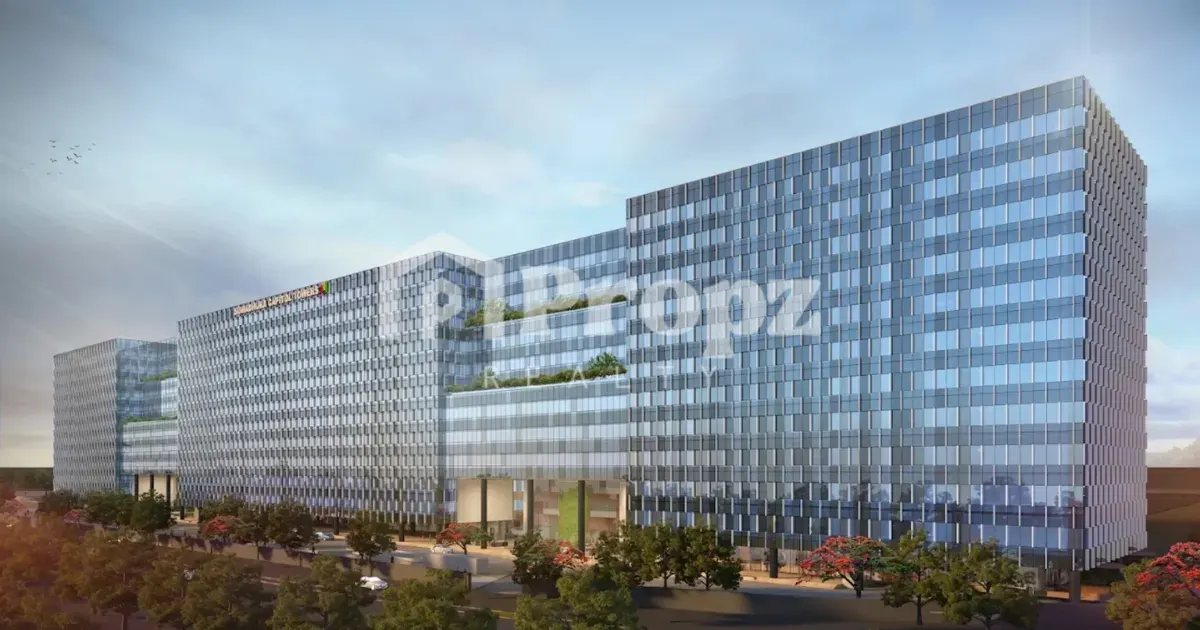 Modern glass facade of Sumadhura Capitol Residences commercial towers with landscaped entrance in Bengaluru