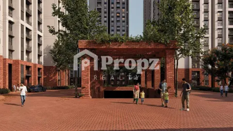Red brick entrance plaza with pedestrian walkway and residential towers at Brigade Belvedere