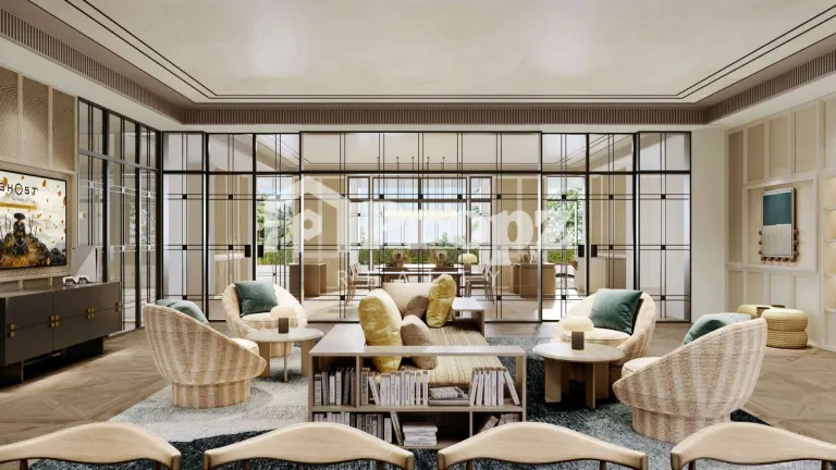Elegant clubhouse lounge with wicker chairs, glass partitions, and views of outdoor terrace