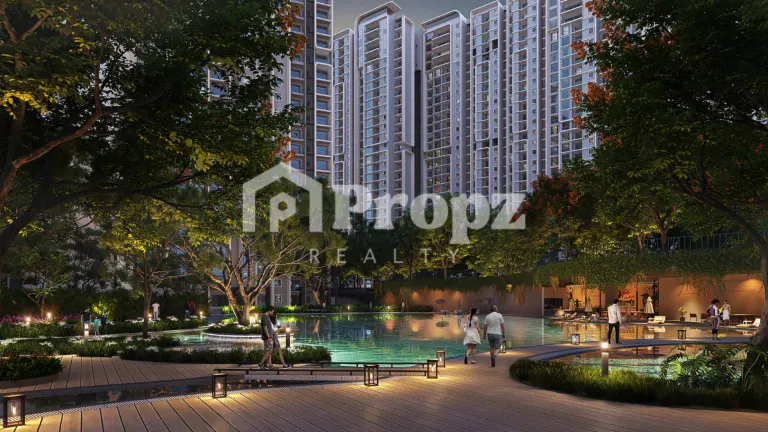 Evening view of swimming pool with wooden deck and high-rise residential towers in the background