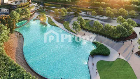 Aerial view of large curved swimming pool surrounded by landscaped gardens and walking paths