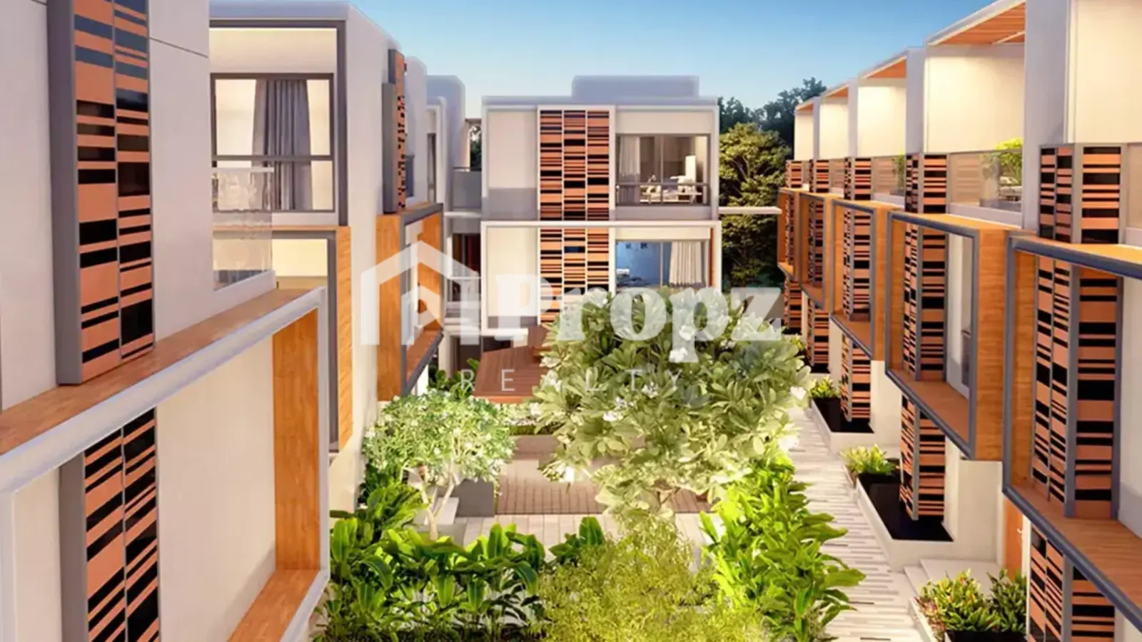 Landscaped courtyard at Sattva La Vita with wooden decking, planters, and modern villa facades