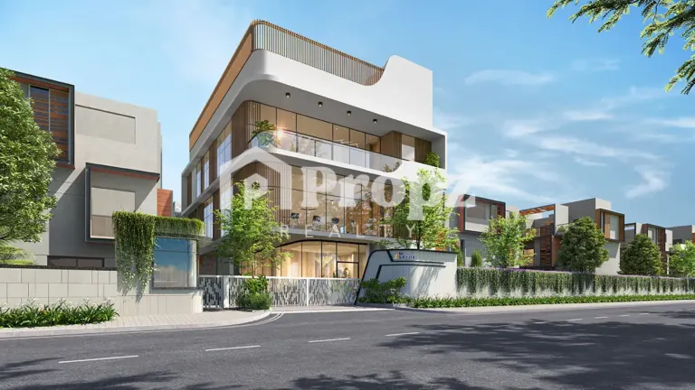 Modern clubhouse entrance at Sattva La Vita with curved architecture and glass facade