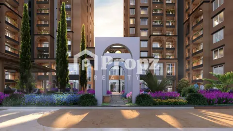 Children's play area with slide and play equipment adjacent to residential tower at Sumadhura Solea