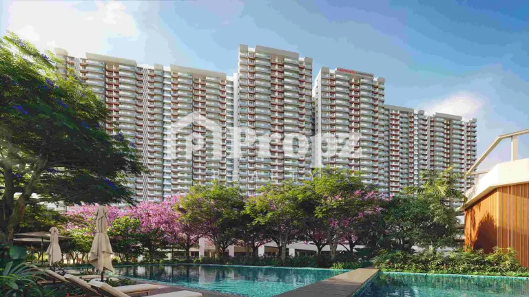 View of Mahindra Blossom residential towers with swimming pool and flowering trees in foreground