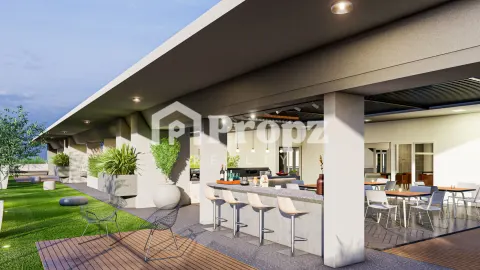 Rooftop terrace with outdoor bar seating, wooden deck, and green lawn area