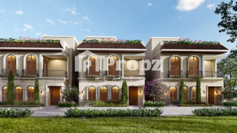 Two-story Mediterranean-style townhomes with arched windows, red tile roofs, and landscaped front yards