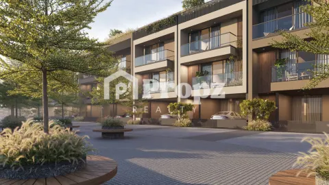 Modern residential building facade with balconies and landscaped driveway at Arvind Forest Trails