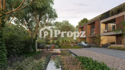 Landscaped entrance with water feature and seating area leading to modern residential building