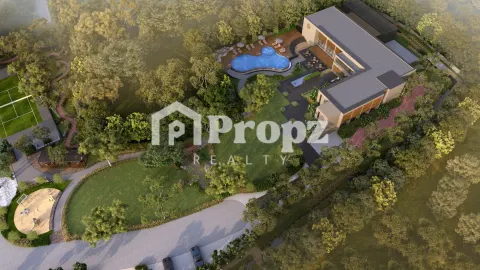 Aerial view of clubhouse with swimming pool surrounded by trees and landscaped gardens