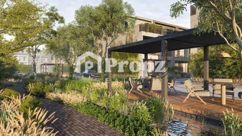 Outdoor seating pavilion with wooden deck surrounded by lush greenery and landscaping