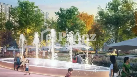 Water fountain plaza with families and children surrounded by trees at Bhartiya Nikoo Homes 8