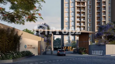 Main entrance gate with Orchid South Park signage, landscaping, and residential tower in background