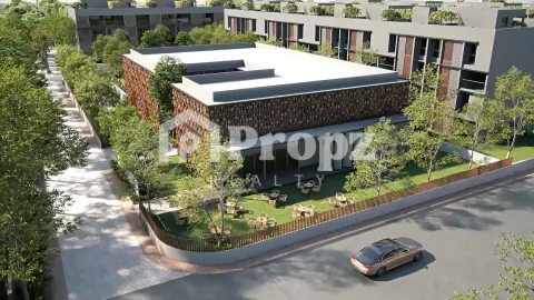 Clubhouse building with decorative screen facade and outdoor seating area surrounded by trees