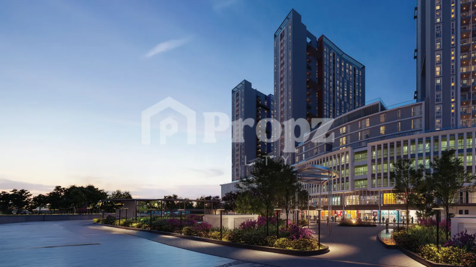 Brigade Granada residential towers with landscaped plaza and retail podium at dusk in Whitefield