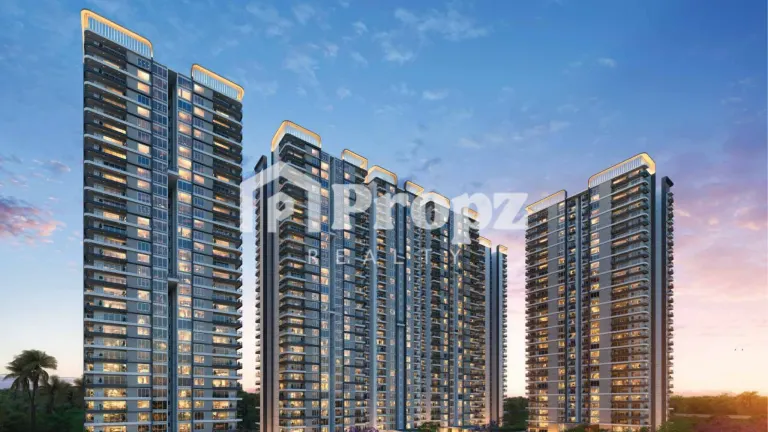 Modern high-rise residential towers with illuminated balconies and curved roofline design at twilight