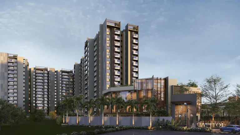 Exterior view of Sumadhura Capitol Residences high-rise towers with glass clubhouse and palm tree landscaping