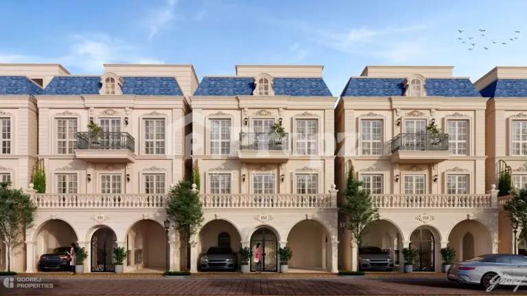 Front view of Godrej Florenne townhomes with blue roofs, balconies, and covered parking areas