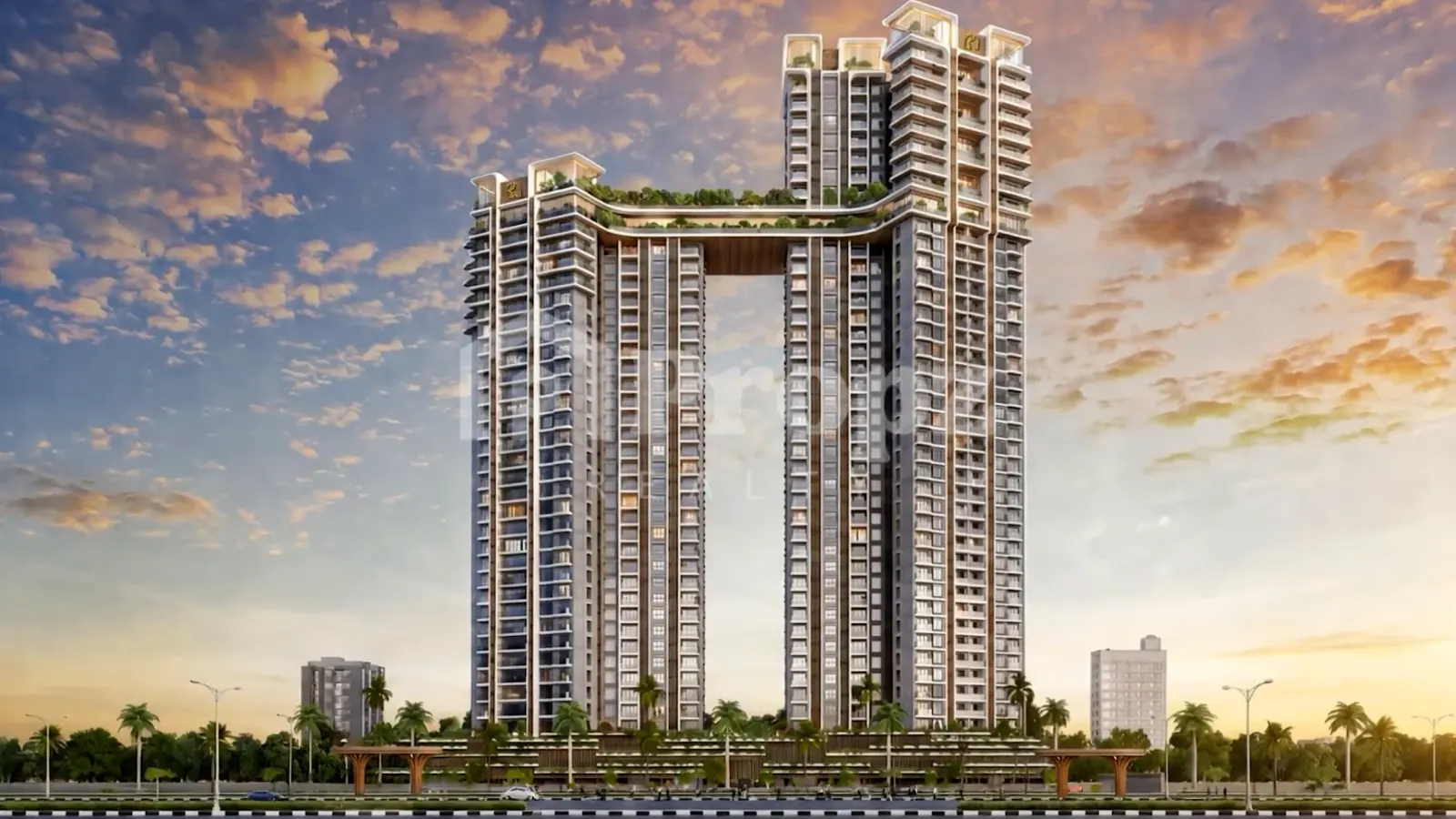 The Rise twin tower residential complex with sky bridge and rooftop gardens at sunset in Budigere Cross