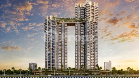 The Rise twin tower facade at sunset with palm-lined entrance and landscaped approach road