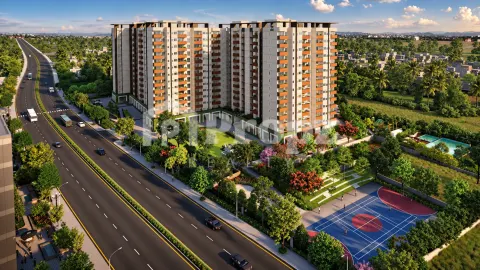 Aerial view of Assetz Soho & Sky towers with landscaped gardens, sports court, and swimming pool
