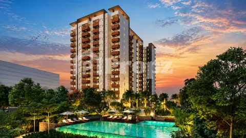 Assetz Soho & Sky residential towers at sunset with illuminated swimming pool and landscaped grounds