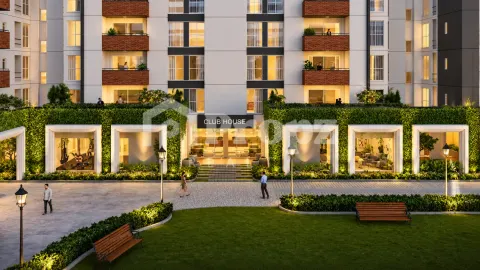 Assetz Soho & Sky club house entrance with green wall facade and illuminated interior spaces