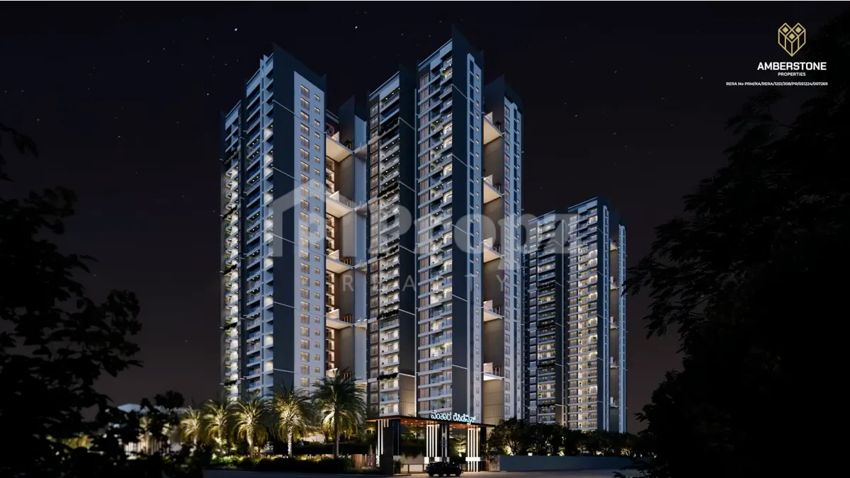 Night view of Amberstone Ventara Residences high-rise towers with illuminated balconies and landscaped entrance
