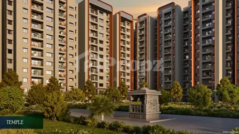 Decorative temple structure in landscaped courtyard with residential towers in background