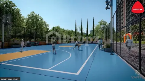 Outdoor basketball court with blue surface surrounded by trees and fencing at Trifecta Vanto