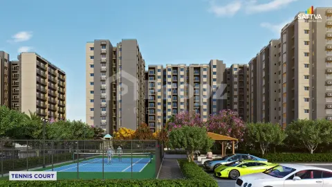 Tennis court with residential apartment buildings and landscaped parking area at Sattva Aeropolis