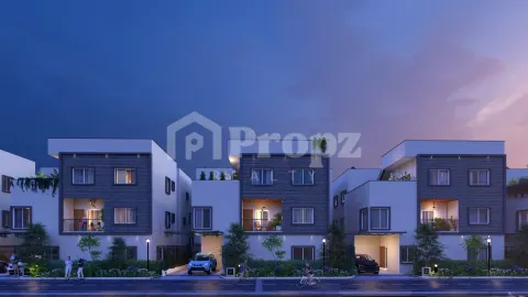 Row of contemporary townhouses with dark wood facades and white walls at twilight