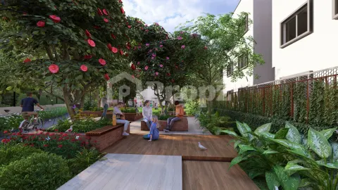 Outdoor seating area with flowering trees, wooden benches, and landscaped gardens