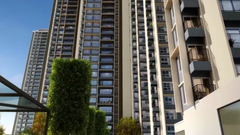 Close-up view of residential tower facades with balconies and vertical green wall at Sattva Lumina
